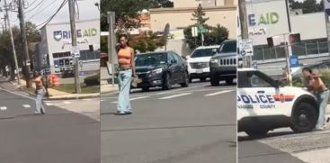 A YOUNG WOMEN POINTED A GUN IN THE MIDDLE OF THE ROAD