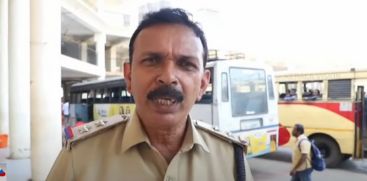 A police officer with drinking water to quench thirst in the scorching heat