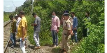 STONE AND PIECE OF CLOSET ON RAILWAY TRACK