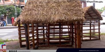 A group of CITU workers making and selling grass huts